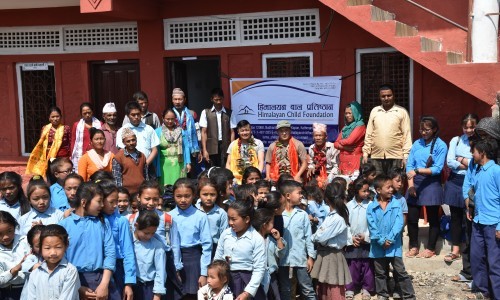 Schoolkids receive educational material by  himalayan child foundation
